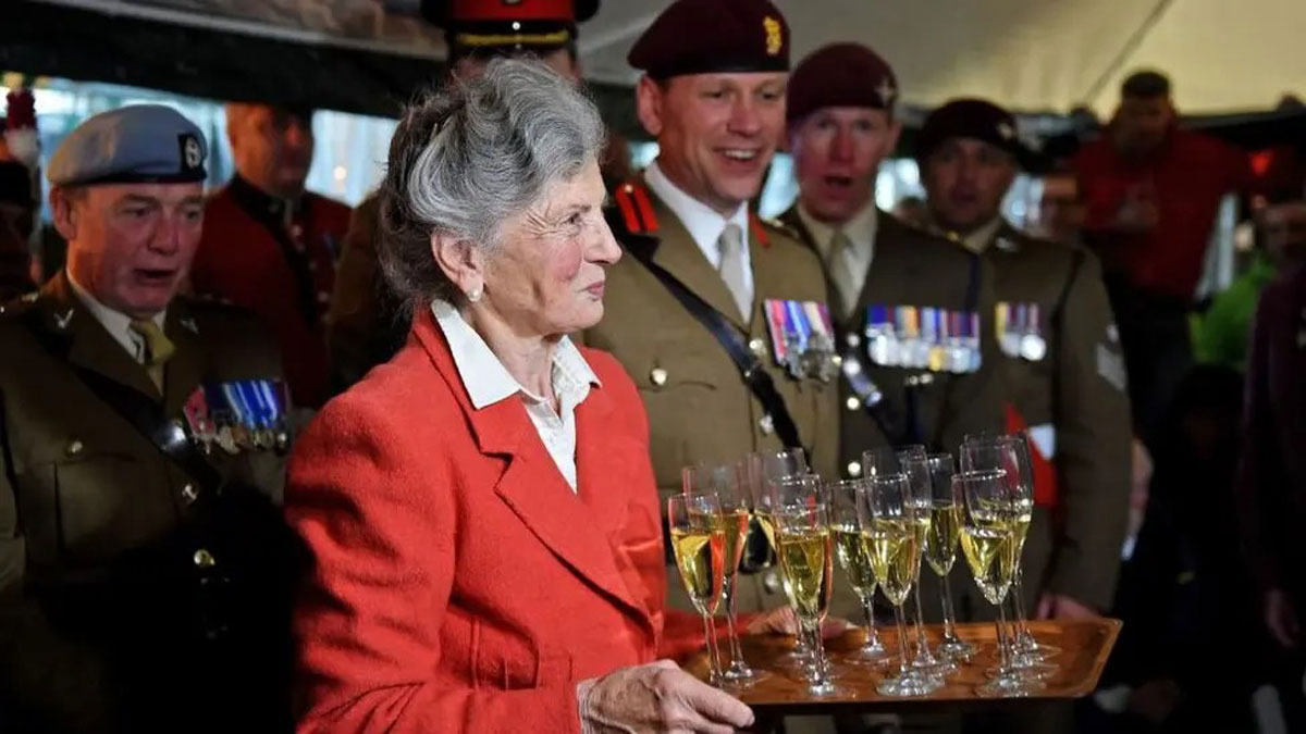 015-Arlette-handing-out-champagne-to-veterans-(BBC)